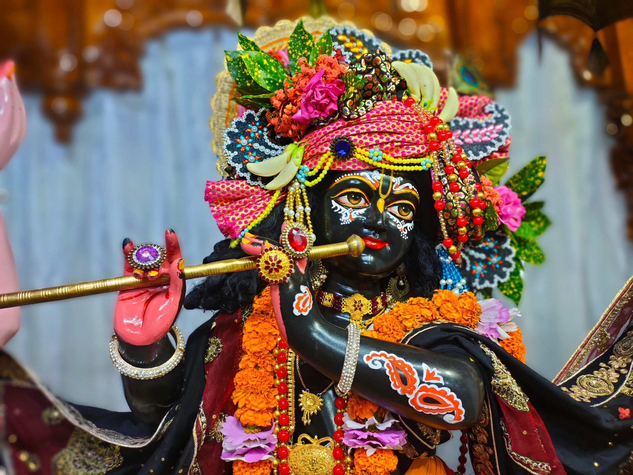 A colorful figurine of a Hindu deity adorned with flowers and ornaments in Rangpur, Bangladesh.