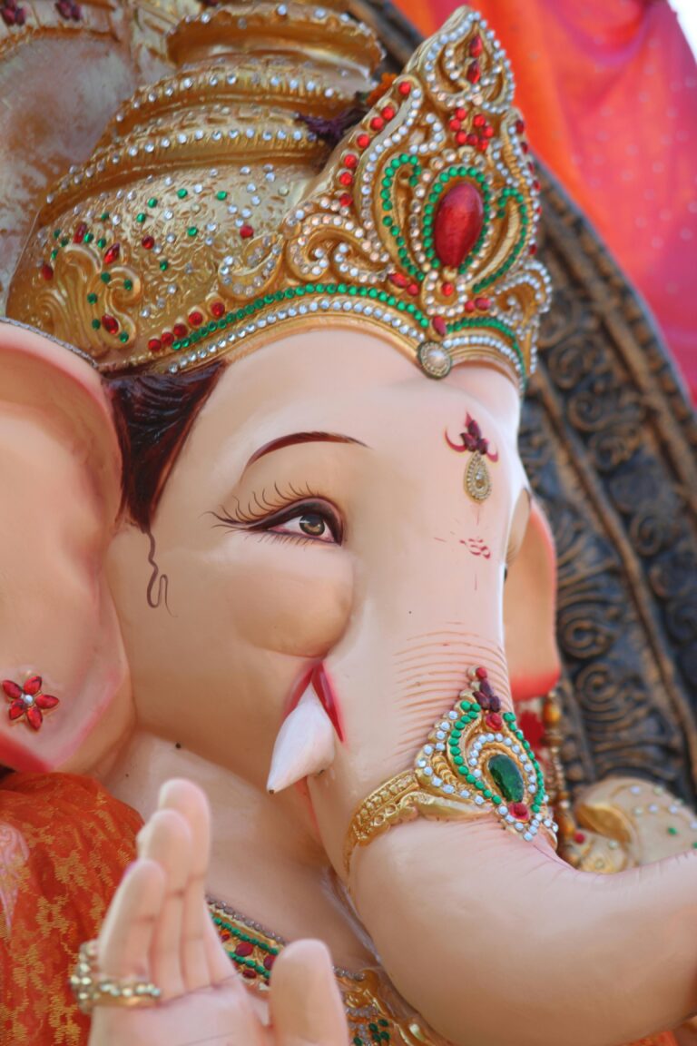 Detailed close-up of a colorful Ganesha statue showcasing intricate ornaments and cultural significance.