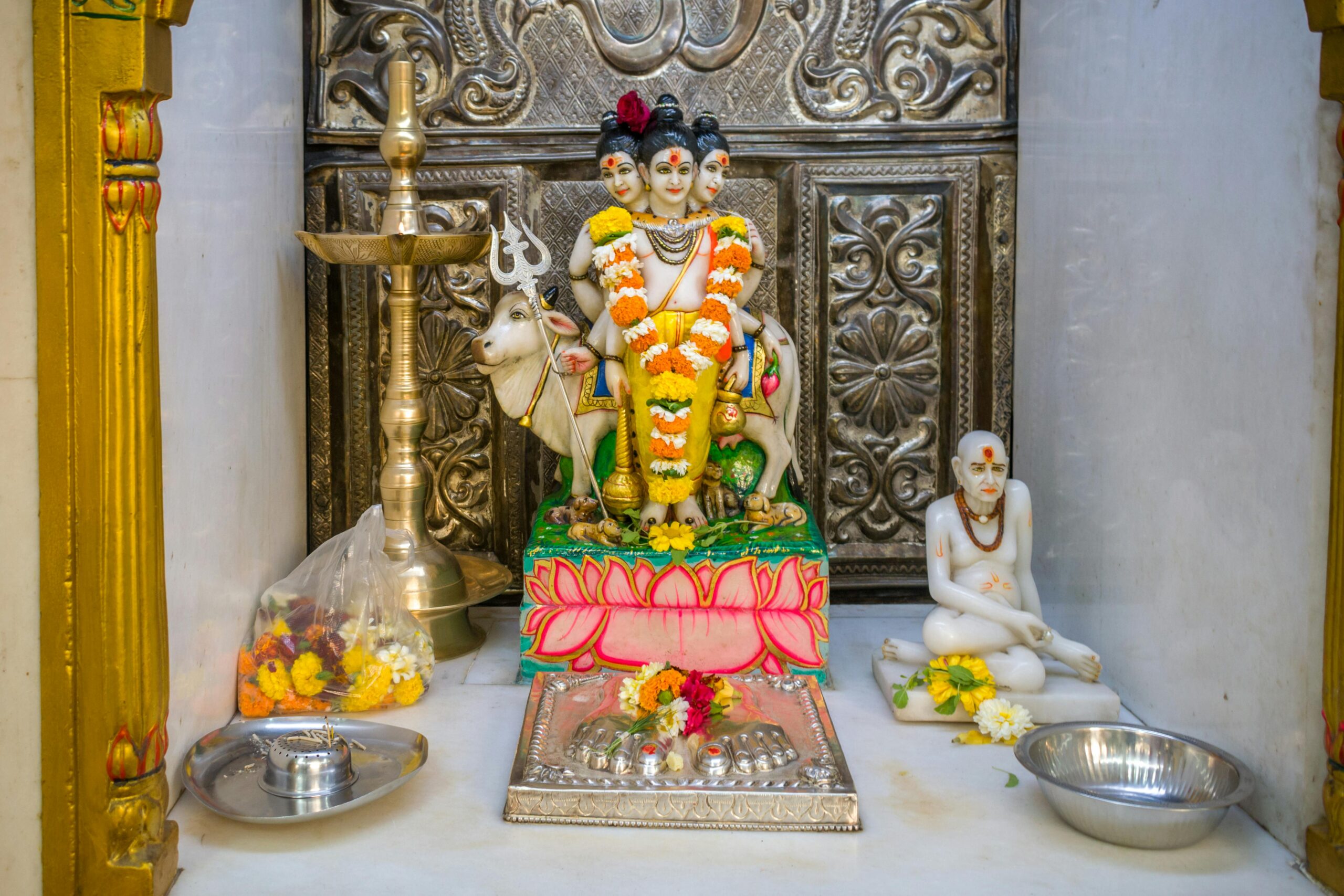 Colorful Hindu altar featuring Lord Dattatreya with spiritual decorations and offerings in Mumbai temple.