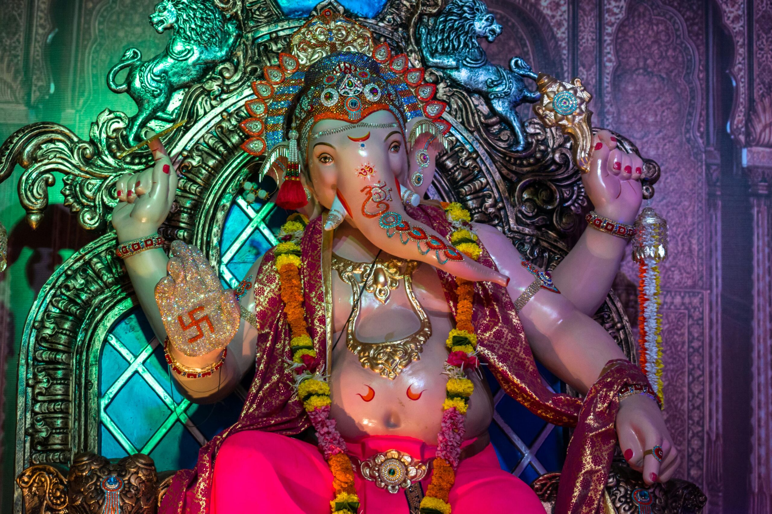 Colorful and ornate statue of Lord Ganesha, adorned for Ganesh Chaturthi celebration.