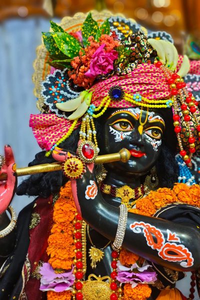 A colorful figurine of a Hindu deity adorned with flowers and ornaments in Rangpur, Bangladesh.